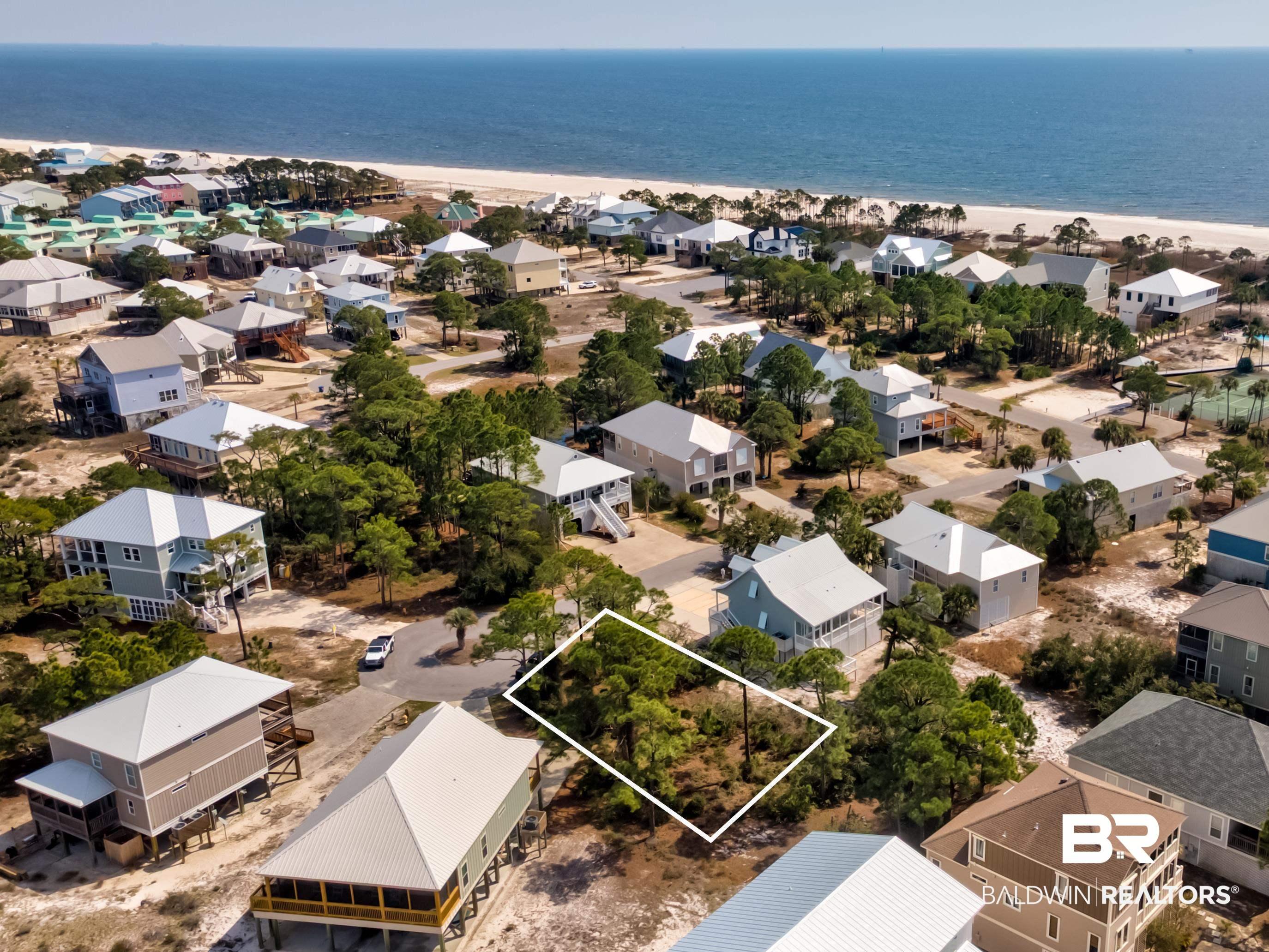 Image 3: Aerial perspective of suburban area featuring expansive beach and property parcel outlined