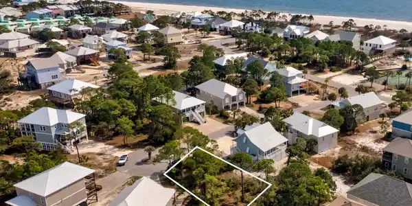 Image 3: Aerial perspective of suburban area featuring expansive beach and property parcel outlined