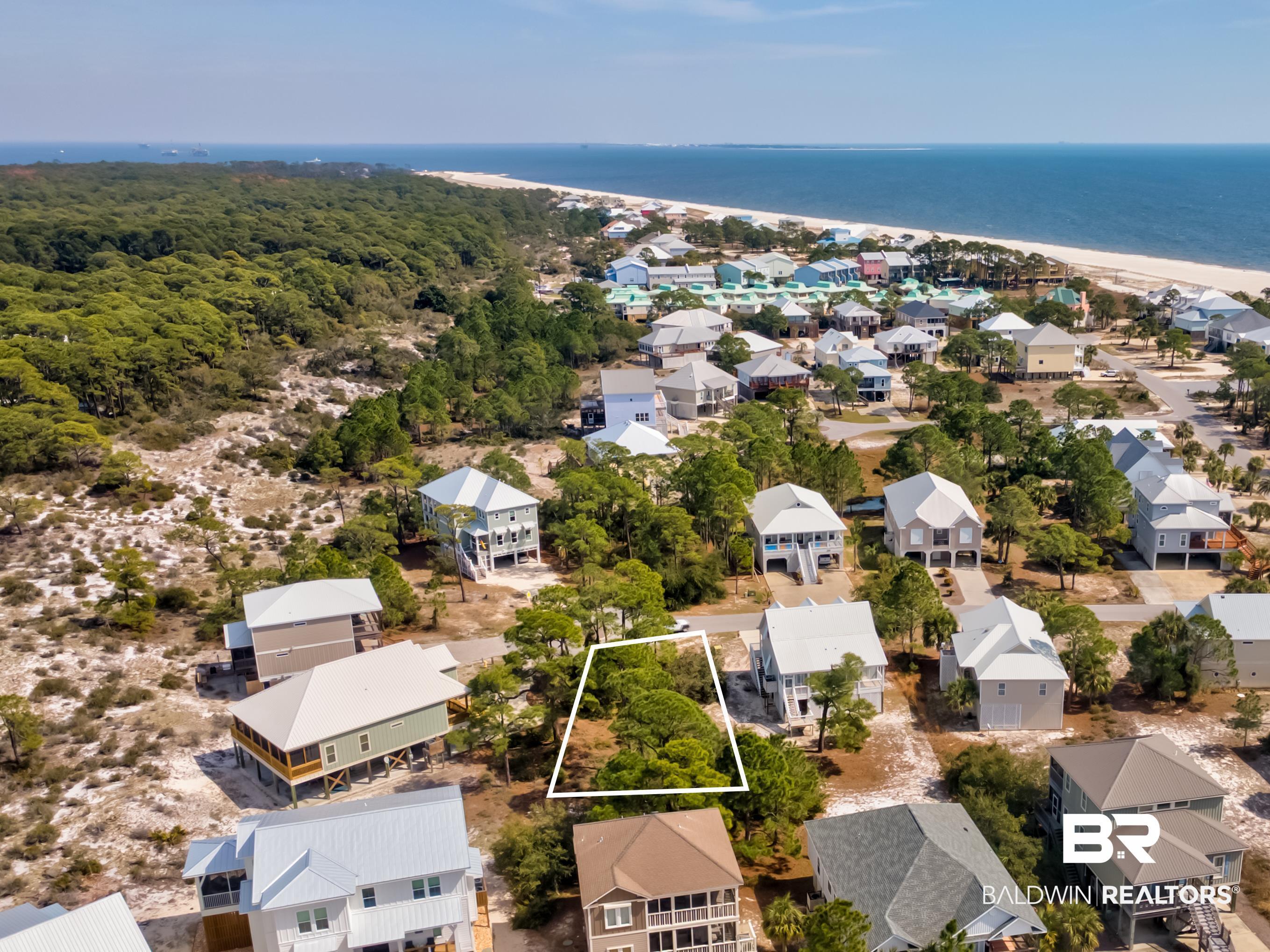 Image 4: Aerial perspective of suburban area featuring property parcel outlined and a nearby body of water