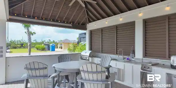 Image 2: View of patio with area for grilling and ceiling fan