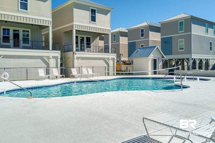 Image 3: Community pool featuring a patio