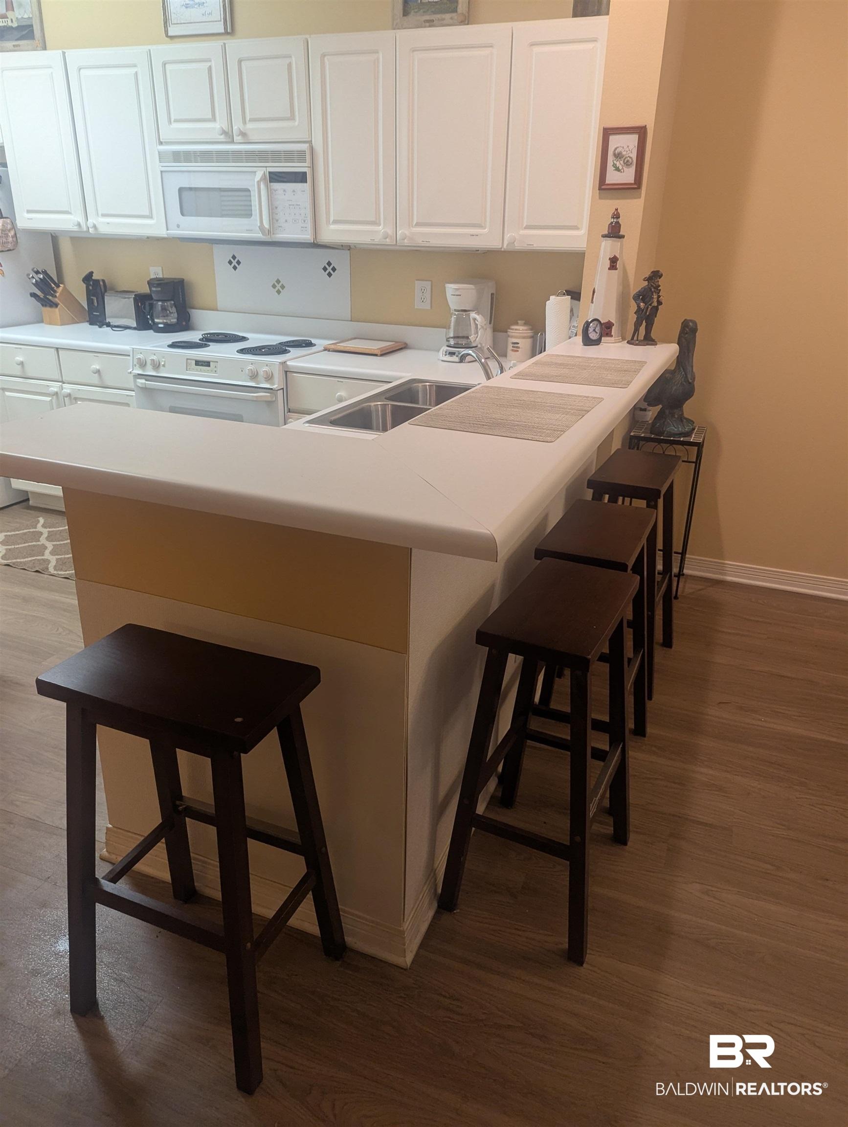 Image 3: Kitchen with a breakfast bar area.