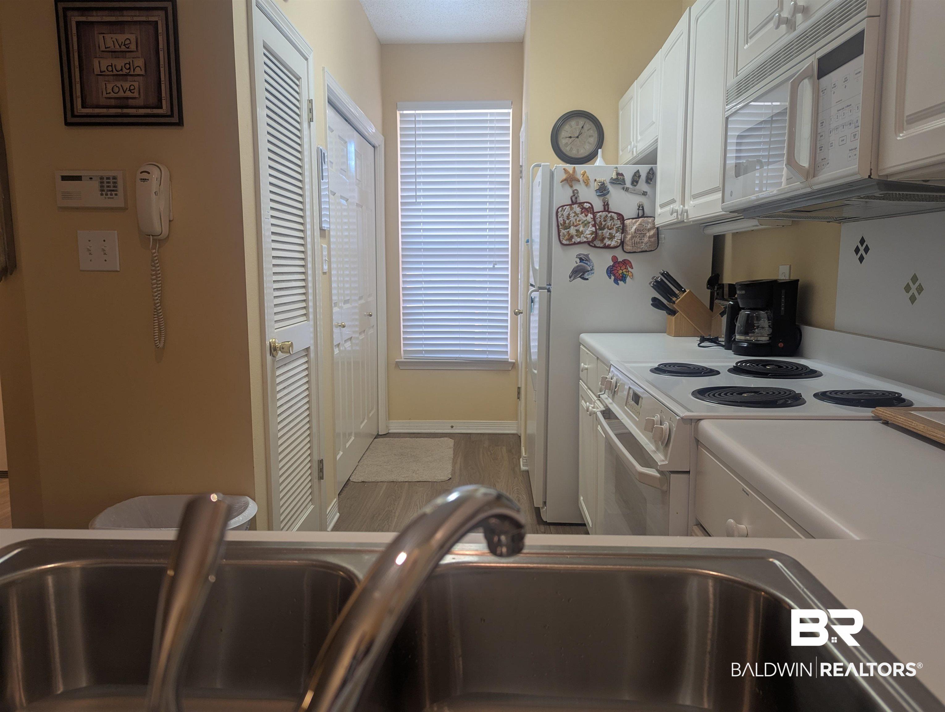 Image 4: Kitchen area with bi-fold doors accessing laundry room.