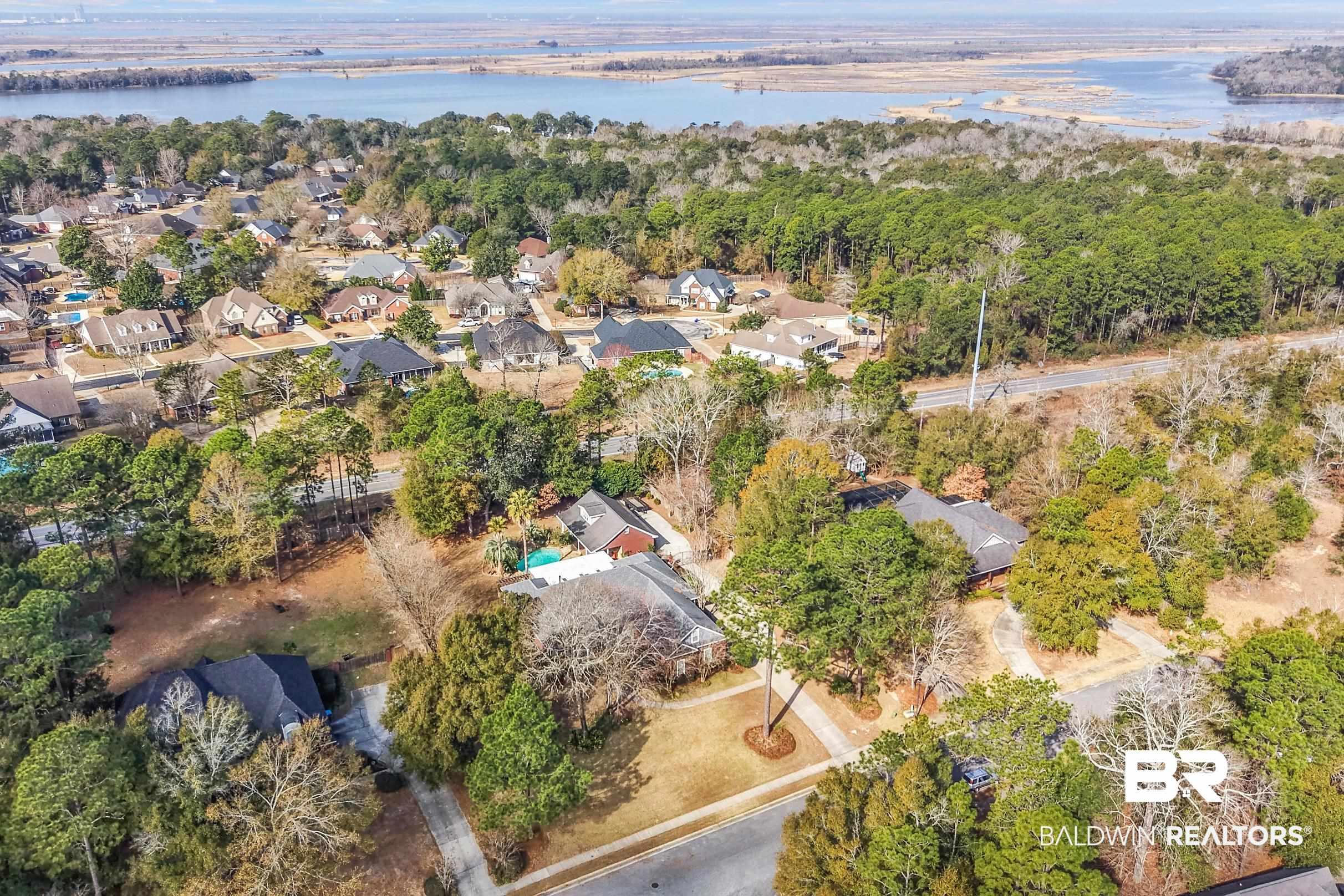 Image 2: Aerial overview of property's location with nearby suburban area and a large body of water