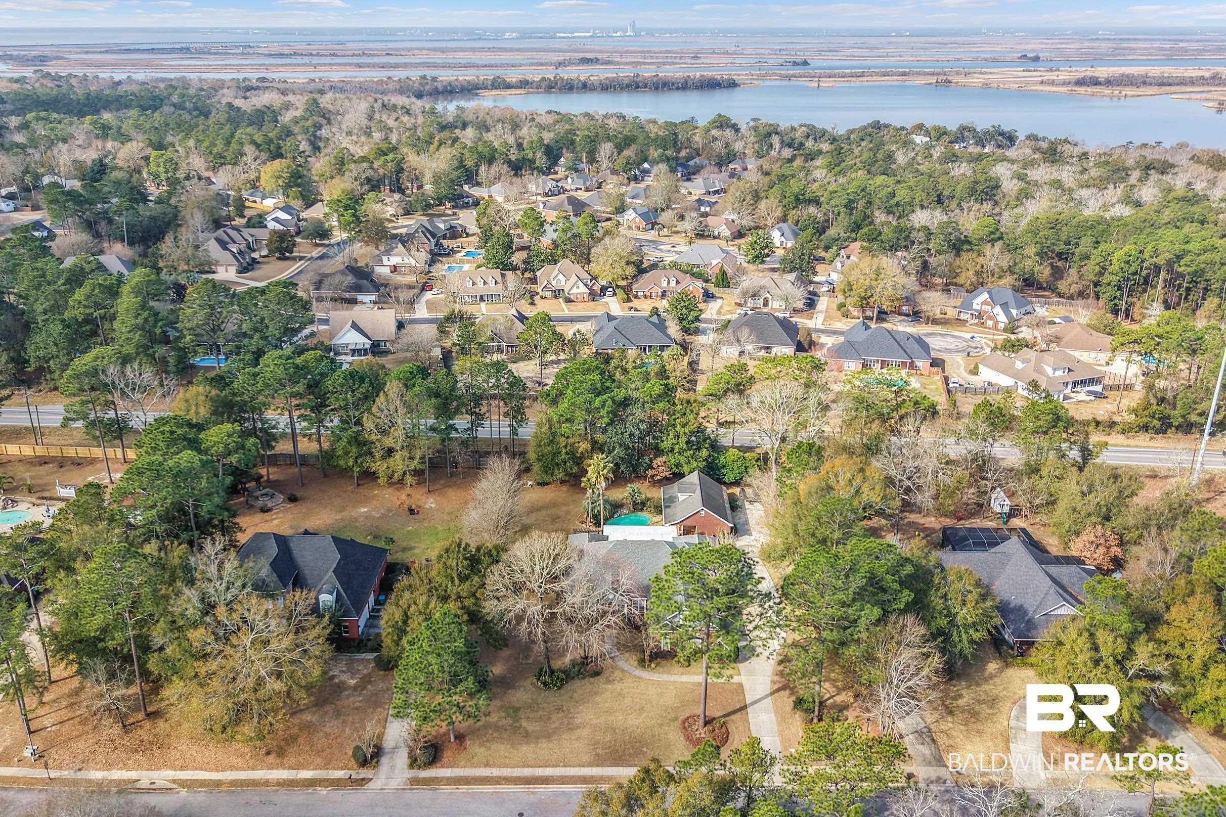 Image 3: Aerial perspective of suburban area with a nearby body of water