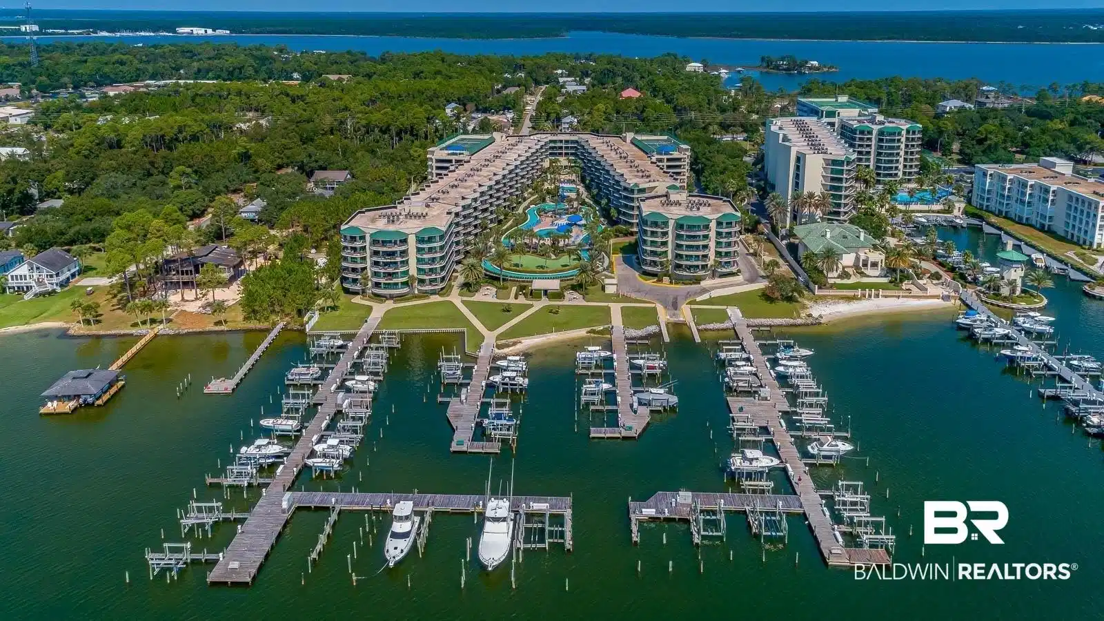 Image 1: Aerial view of property and surrounding area featuring a nearby body of water