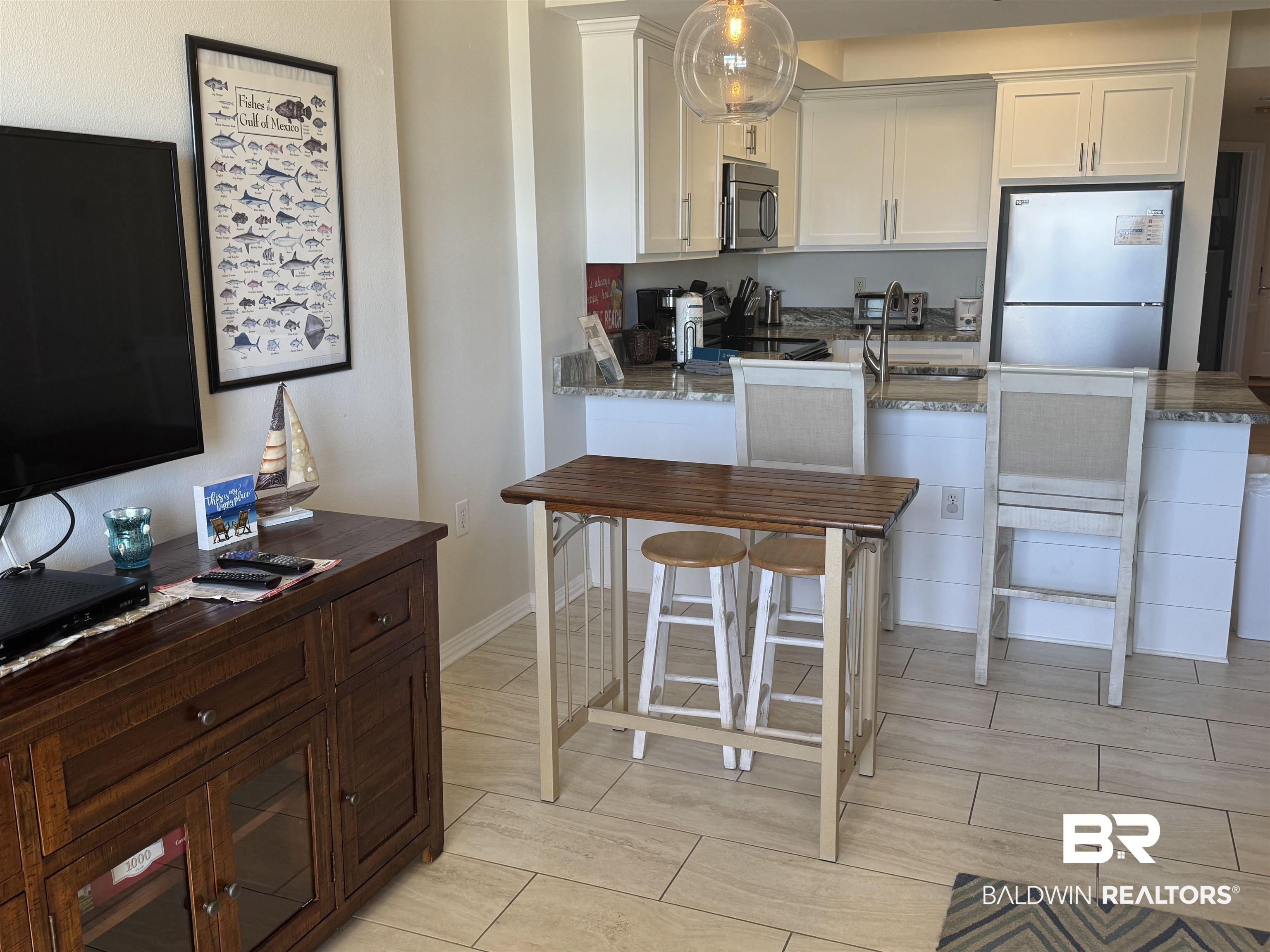 Image 4: Contemporary kitchen with white cabinetry and stainless steel appliances