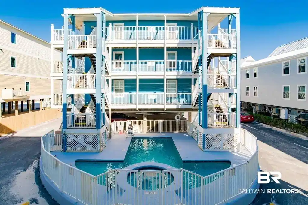 Image 1: Pool featuring stairway and a hot tub