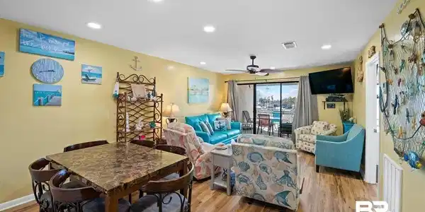 Image 4: Open-concept living space featuring wood-finish flooring, recessed lighting, and a ceiling fan