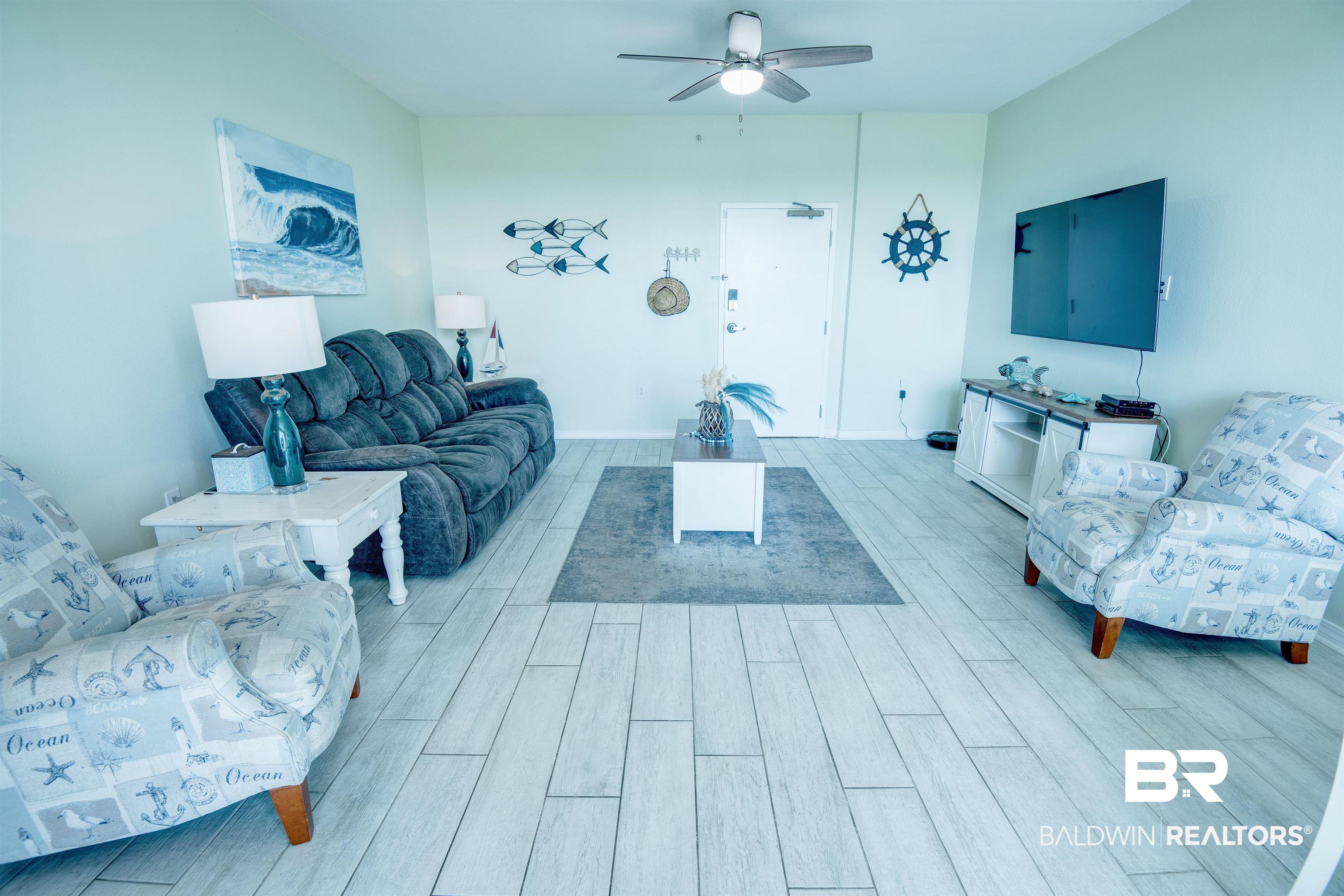Image 4: Living area featuring wood finished floors and ceiling fan