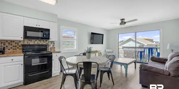 Image 3: Dining room with light wood finished floors and a ceiling fan