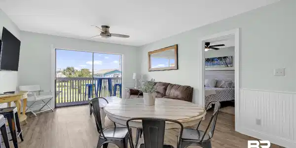 Image 4: Dining area featuring ceiling fan, light wood-style flooring, and a wainscoted wall