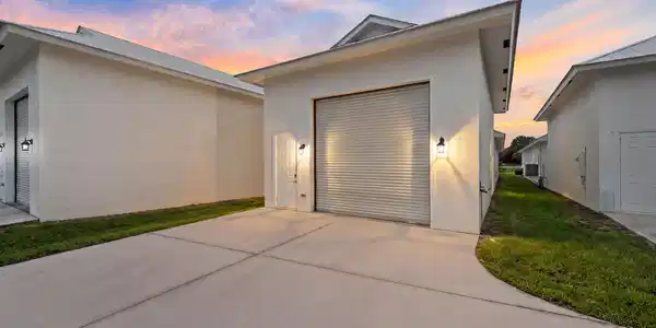 Image 3: Back of home, attached 4 car garage