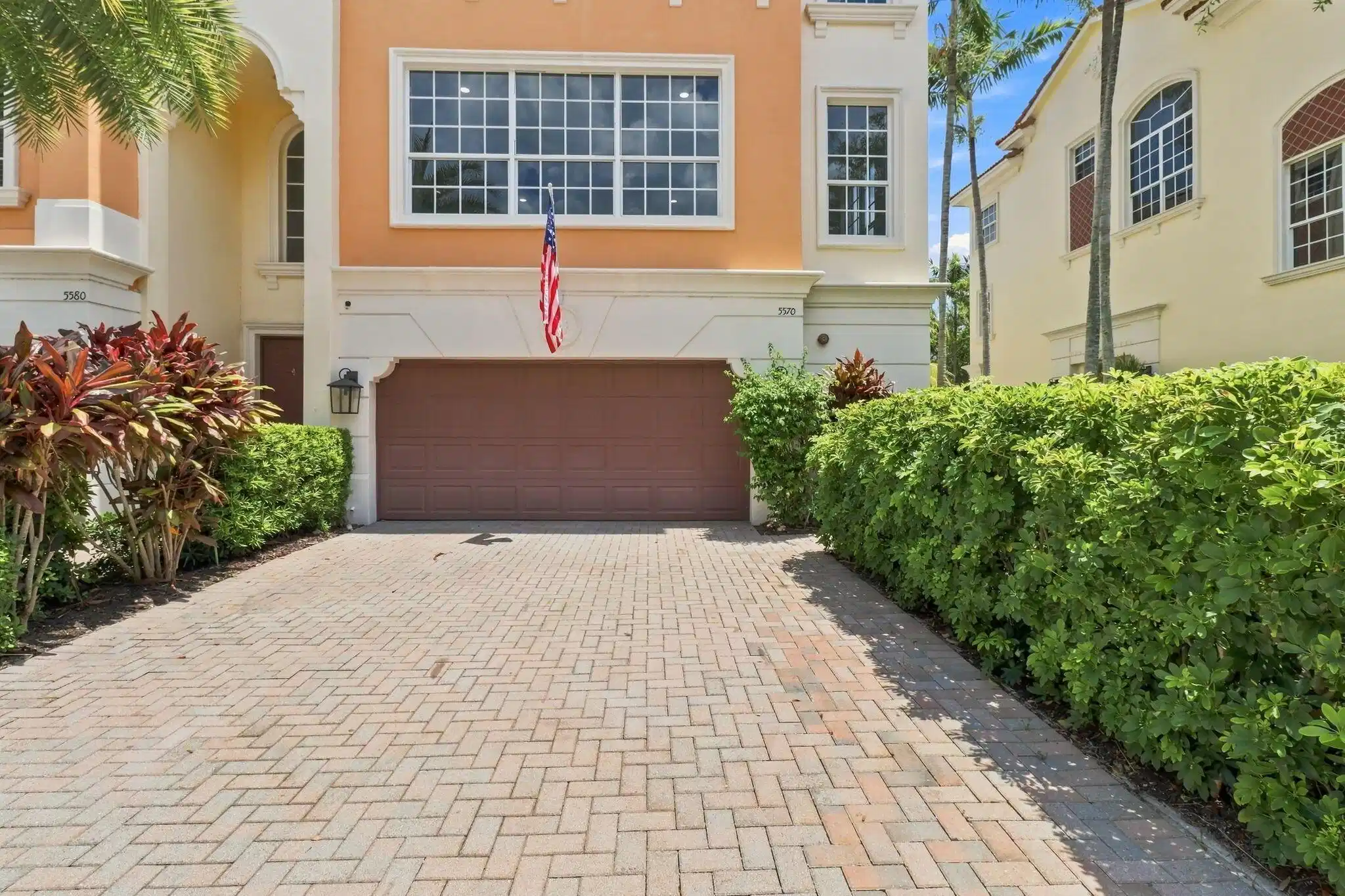 Image 1: Paver driveway leading to an attached garage, feat