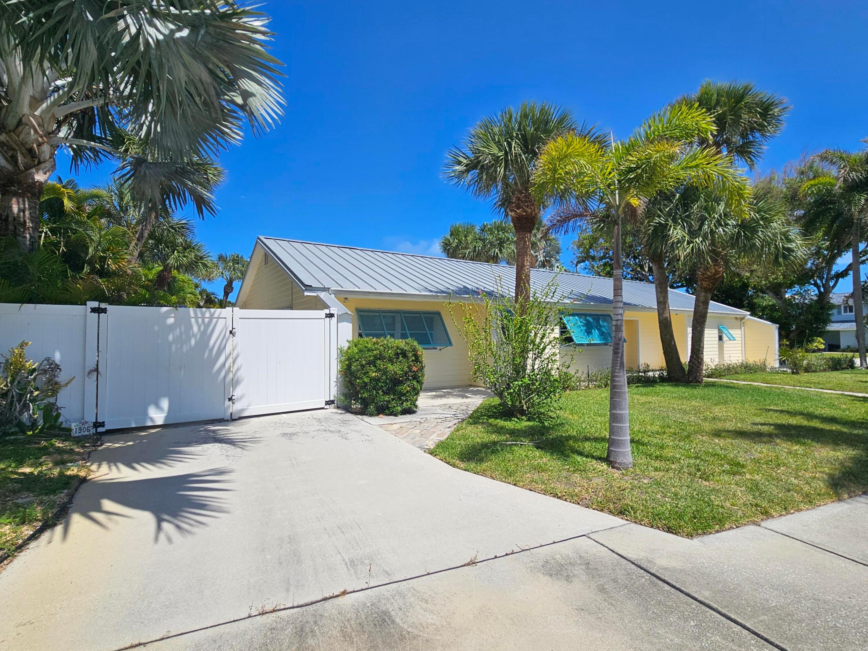 Image 4: Front elevation of home w/ driveway from S Ocean D