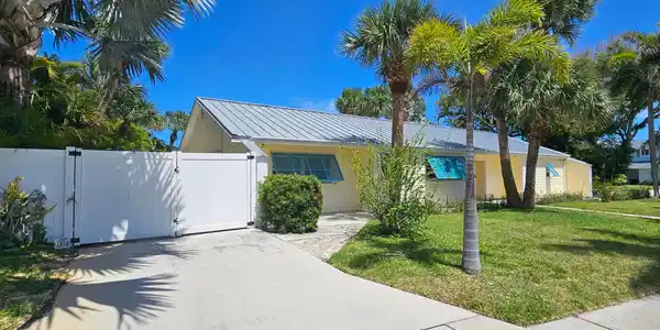 Image 4: Front elevation of home w/ driveway from S Ocean D