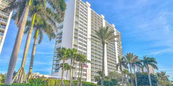 Image 3: High-rise building with multiple balconies, surrou