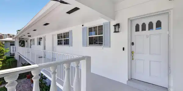 Image 2: Exterior corridor access with white balustrade rai