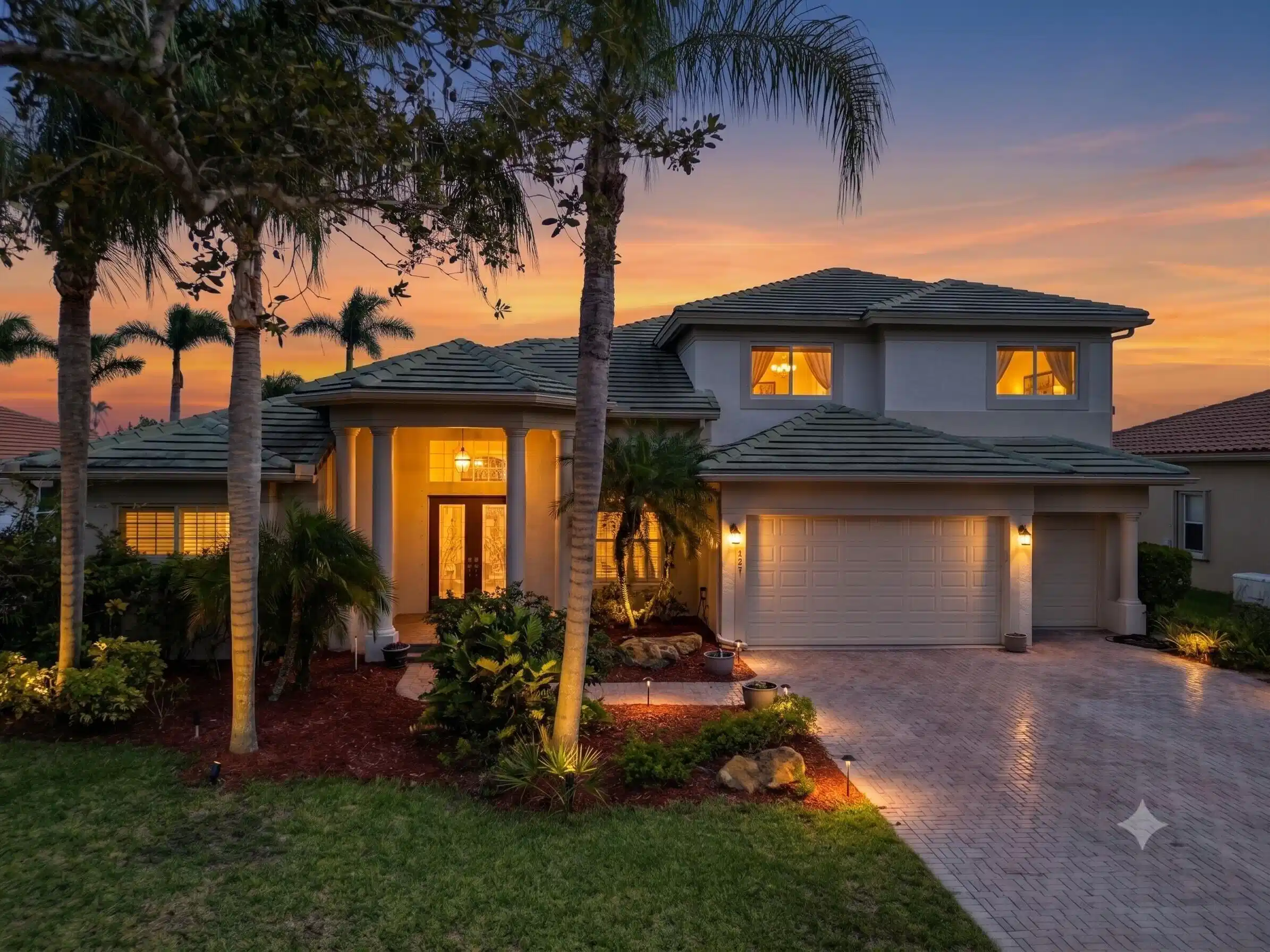 Image 1: Two-story residence featuring a tile roof, paved d