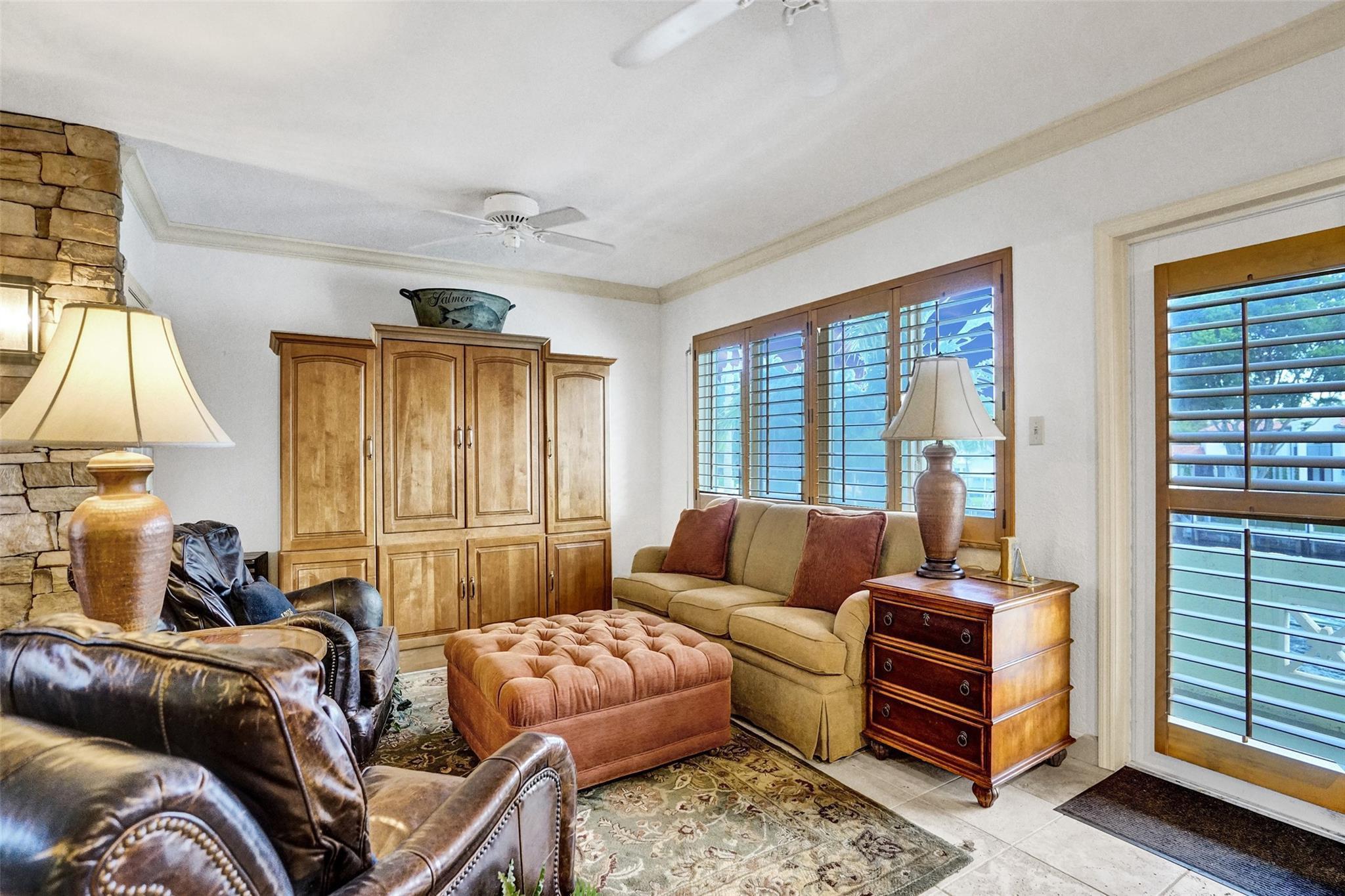 Image 2: Living room with a wall of windows facing the icon
