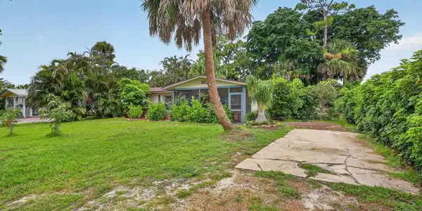 Image 4: Single-story residence featuring a screened porch