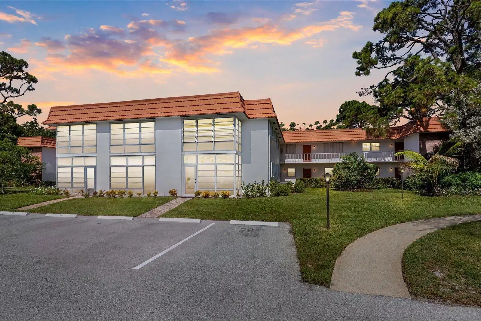 Image 1: Contemporary multi-story building featuring expans