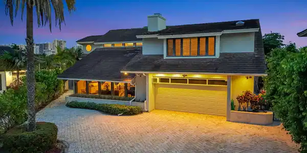 Image 3: Elegant twilight curb appeal introduces the reside