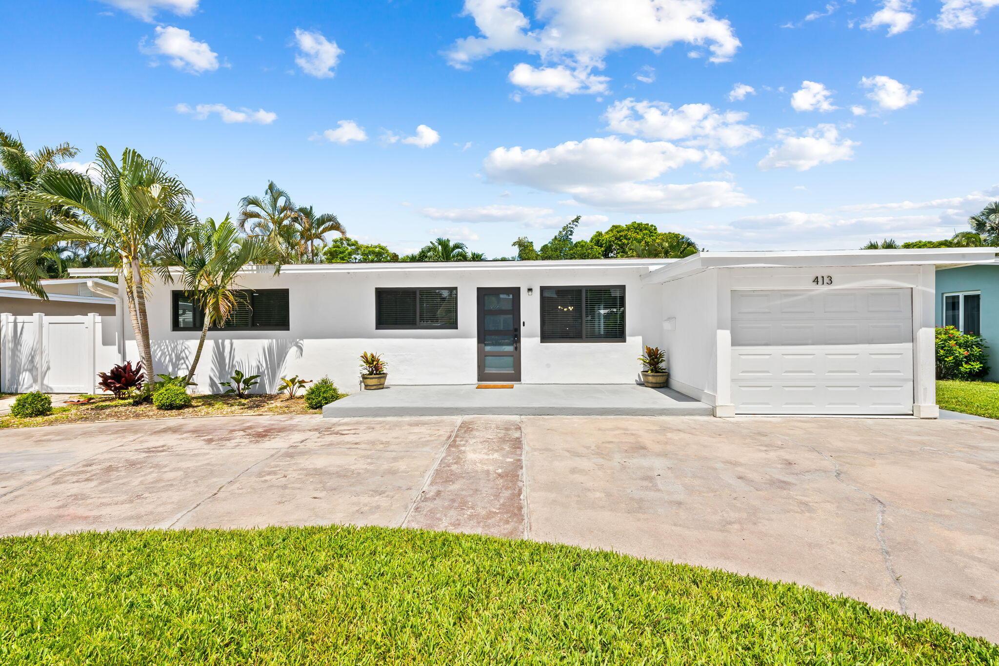 Image 1: Modern white exterior with dark-framed windows, a