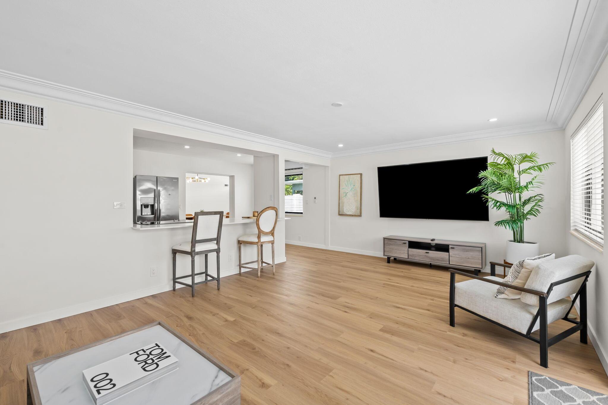 Image 3: Open-concept living space featuring wood-finish fl