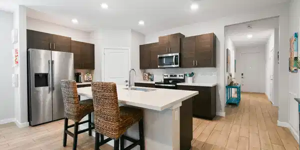 Image 3: Modern kitchen featuring a central island with an