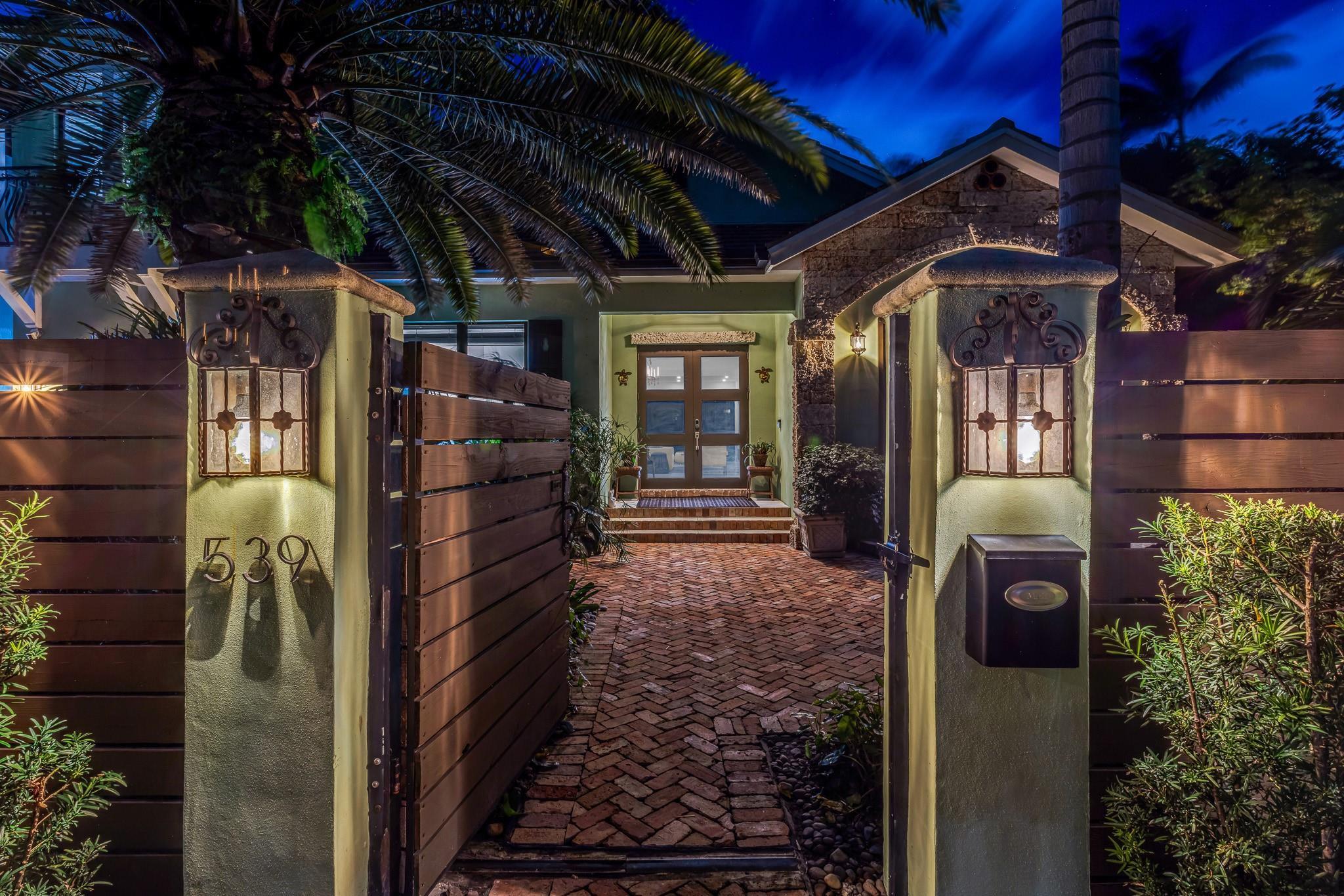 Image 3: Beautifully landscaped, gated courtyard leading to