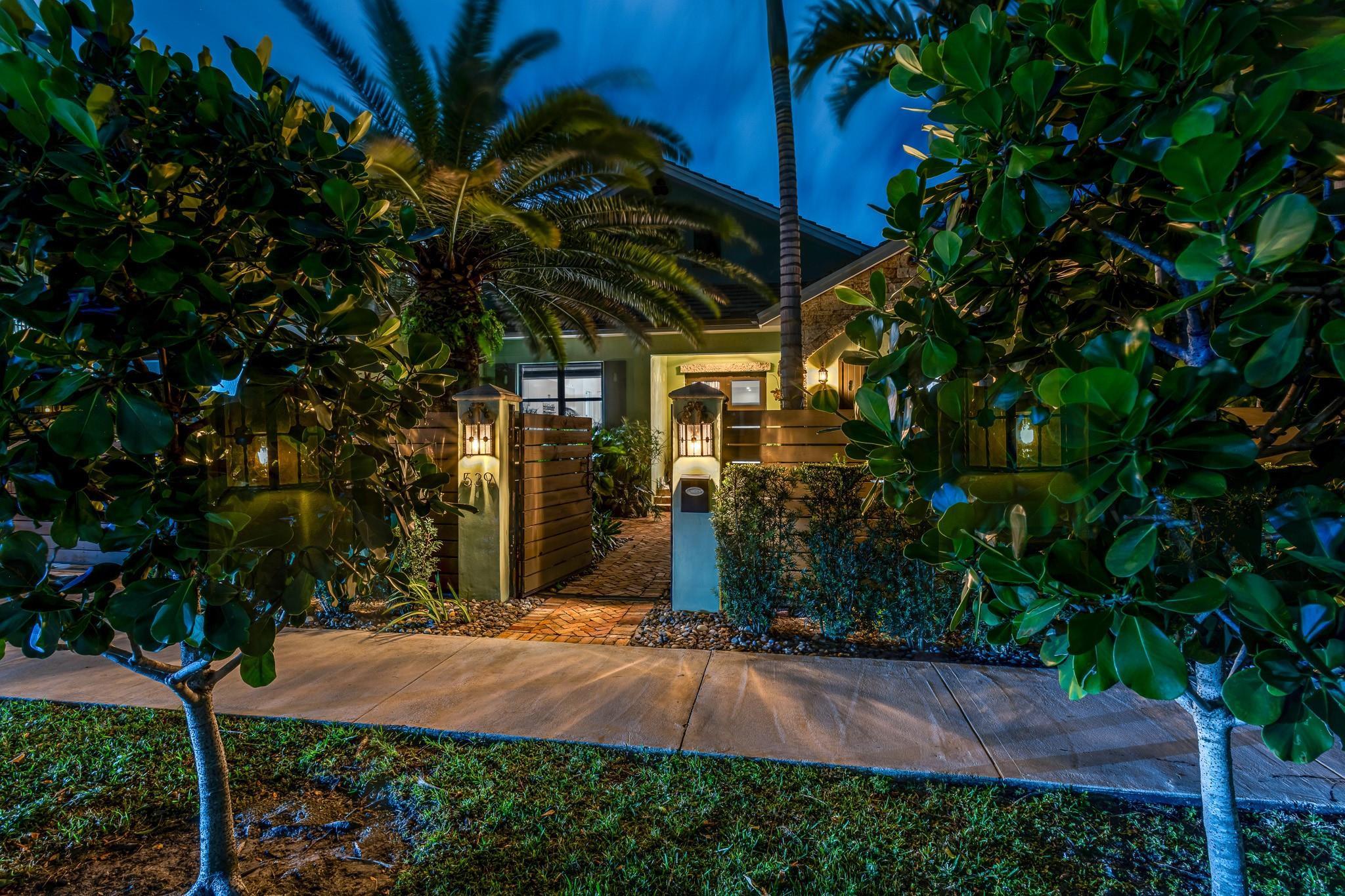 Image 4: Beautifully landscaped, gated courtyard leading to