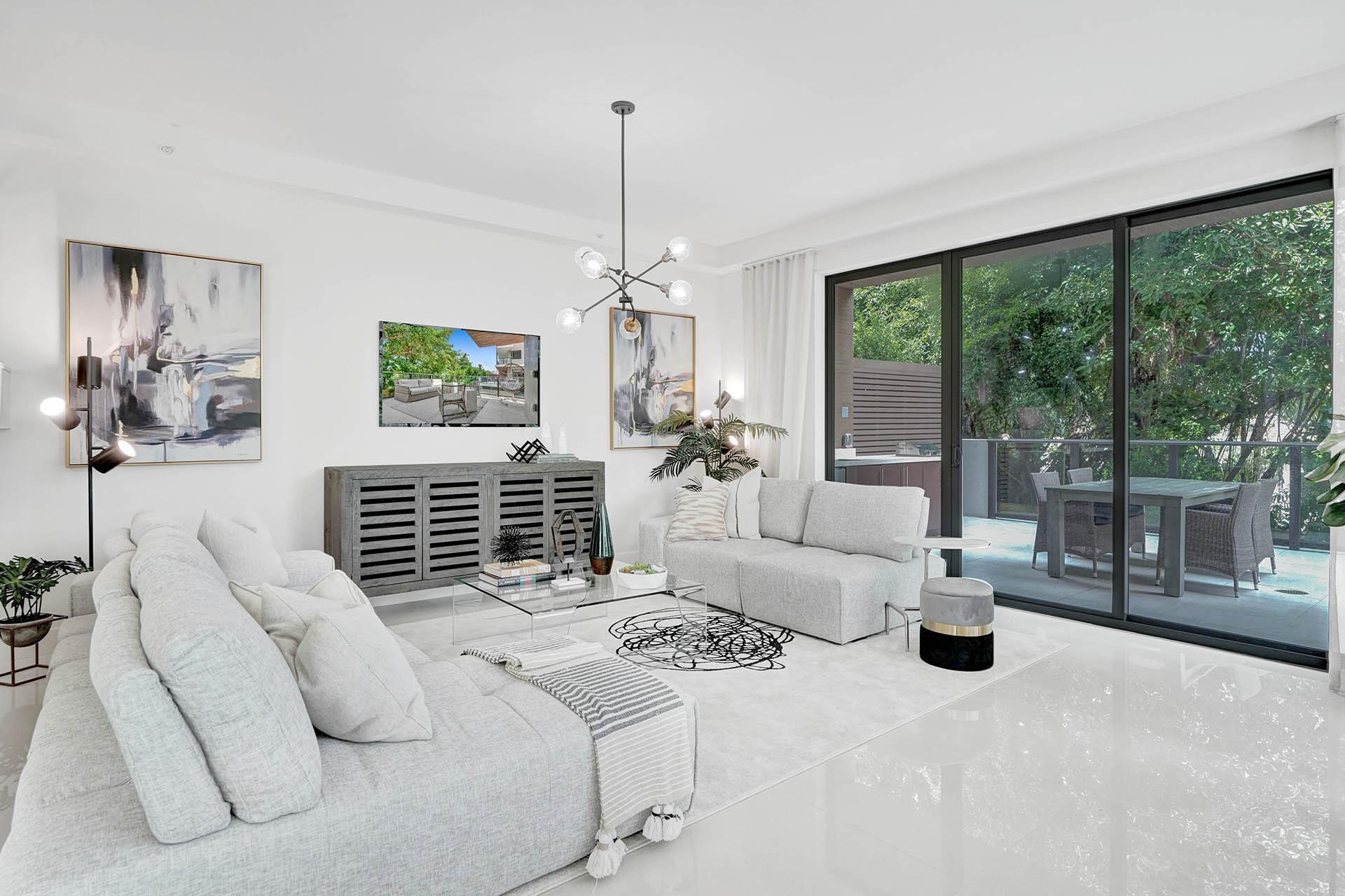 Image 1: Bright, light-filled living room showcasing floor-
