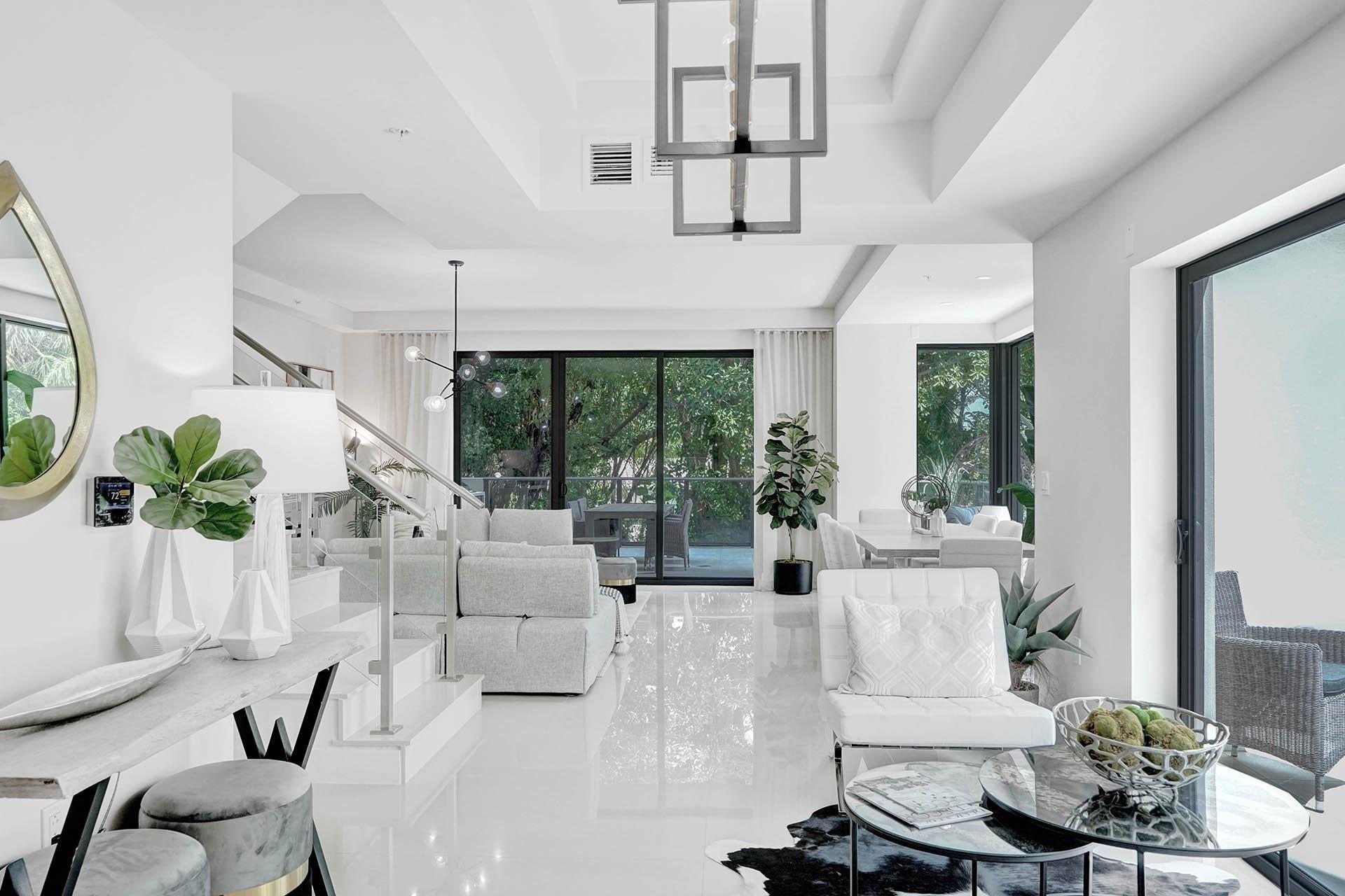Image 4: Open-concept living area featuring high-gloss floo