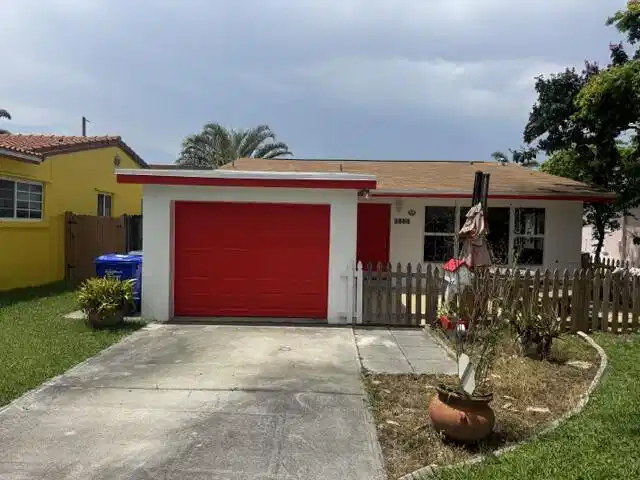 Image 1: freshly painted house with large parking in front