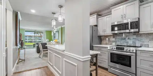 Image 3: Updated and open kitchen boasts shaker style cabin