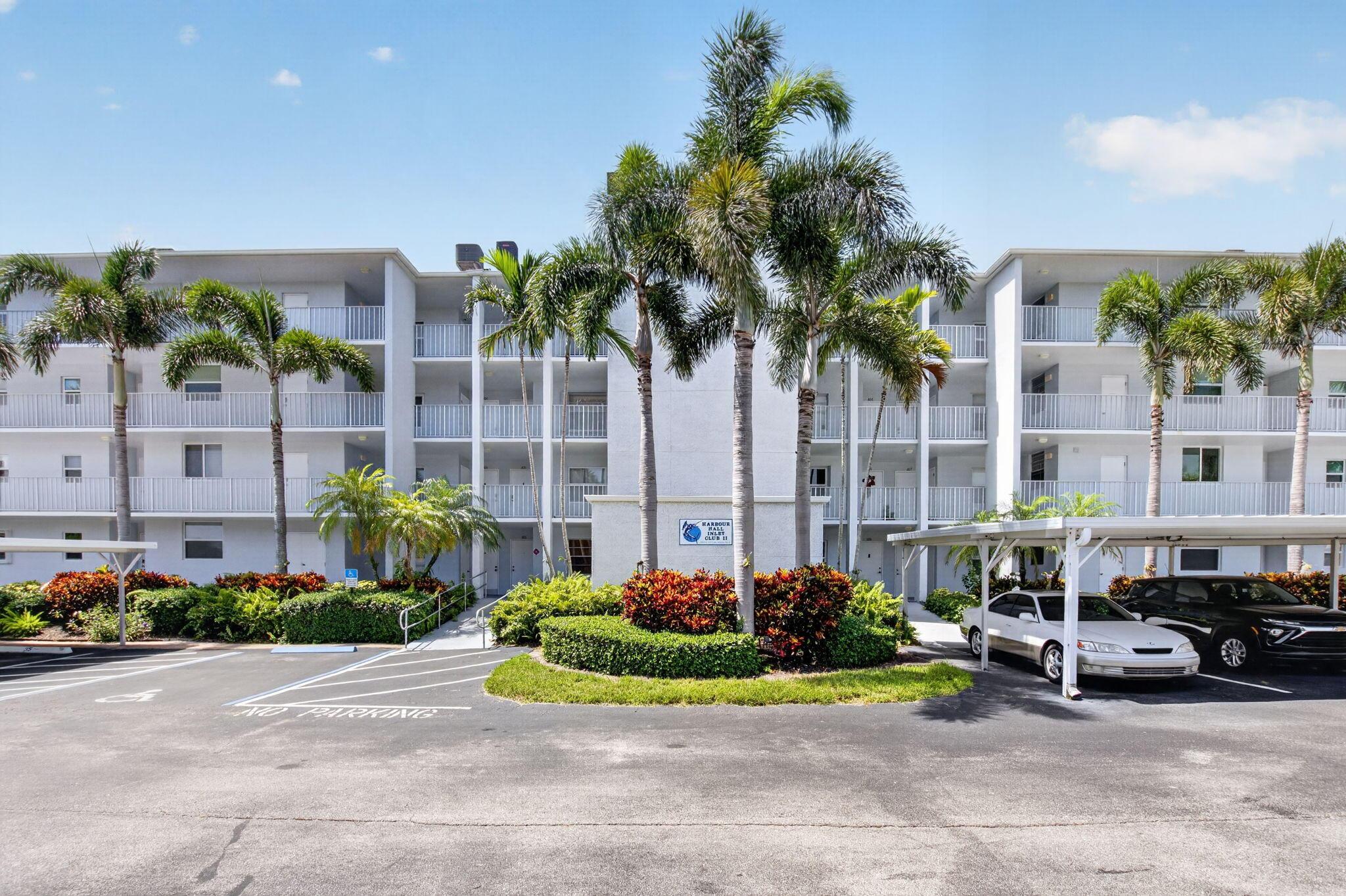 Image 1: Multi-story condominium building featuring gray ex