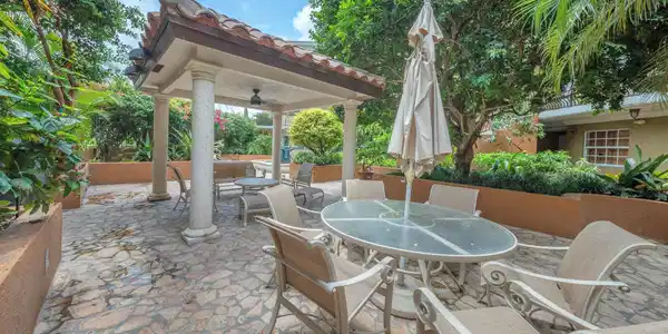 Image 3: Relax outdoors in a serene gazebo patio area