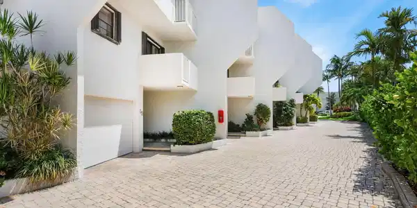 Image 2: White stucco exterior with multiple balconies, pri