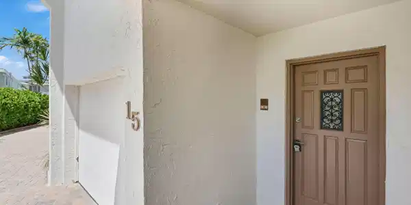 Image 3: Textured exterior wall finish, paneled entry door
