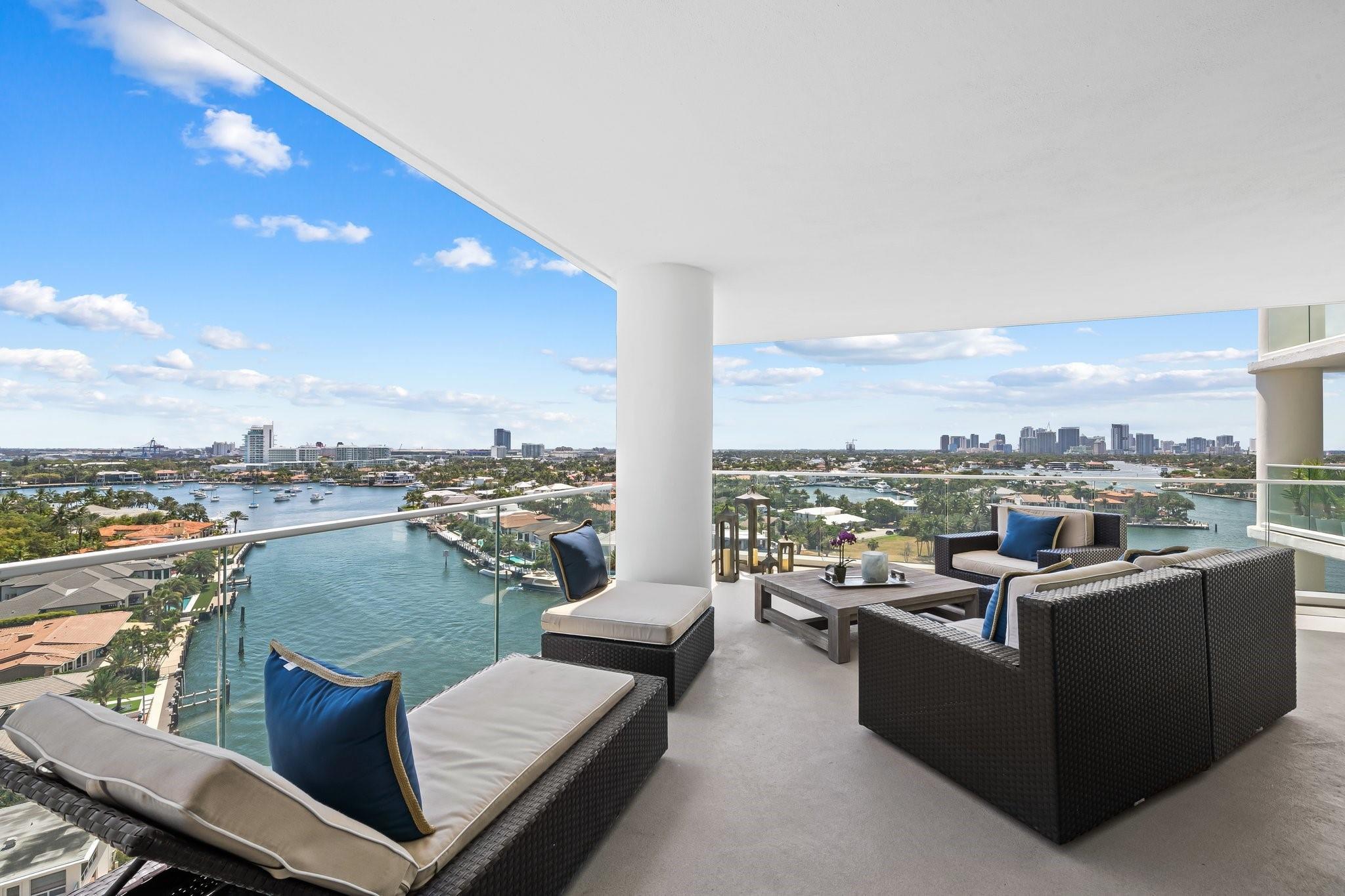 Image 4: Expansive outdoor terrace featuring a glass railin