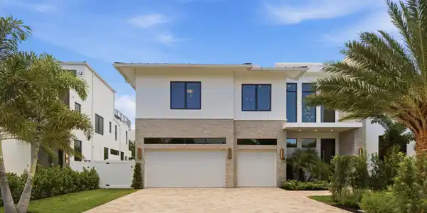 Image 2: Modern exterior with a light-colored stucco finish