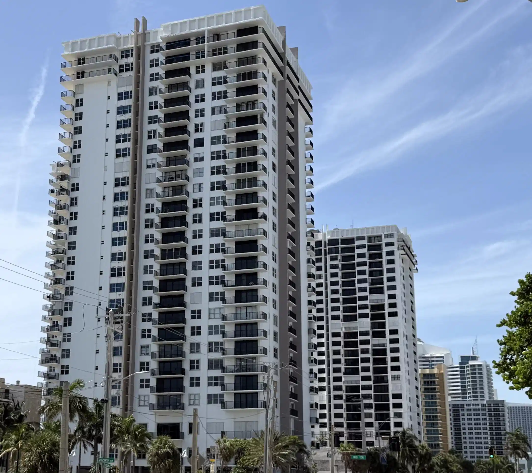 Image 1: High-rise tower featuring multiple balconies, a wh