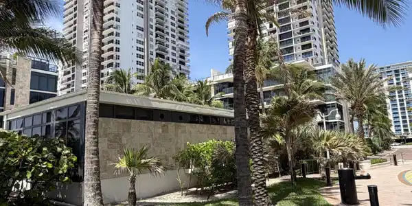 Image 2: Lush tropical landscaping with manicured lawns and