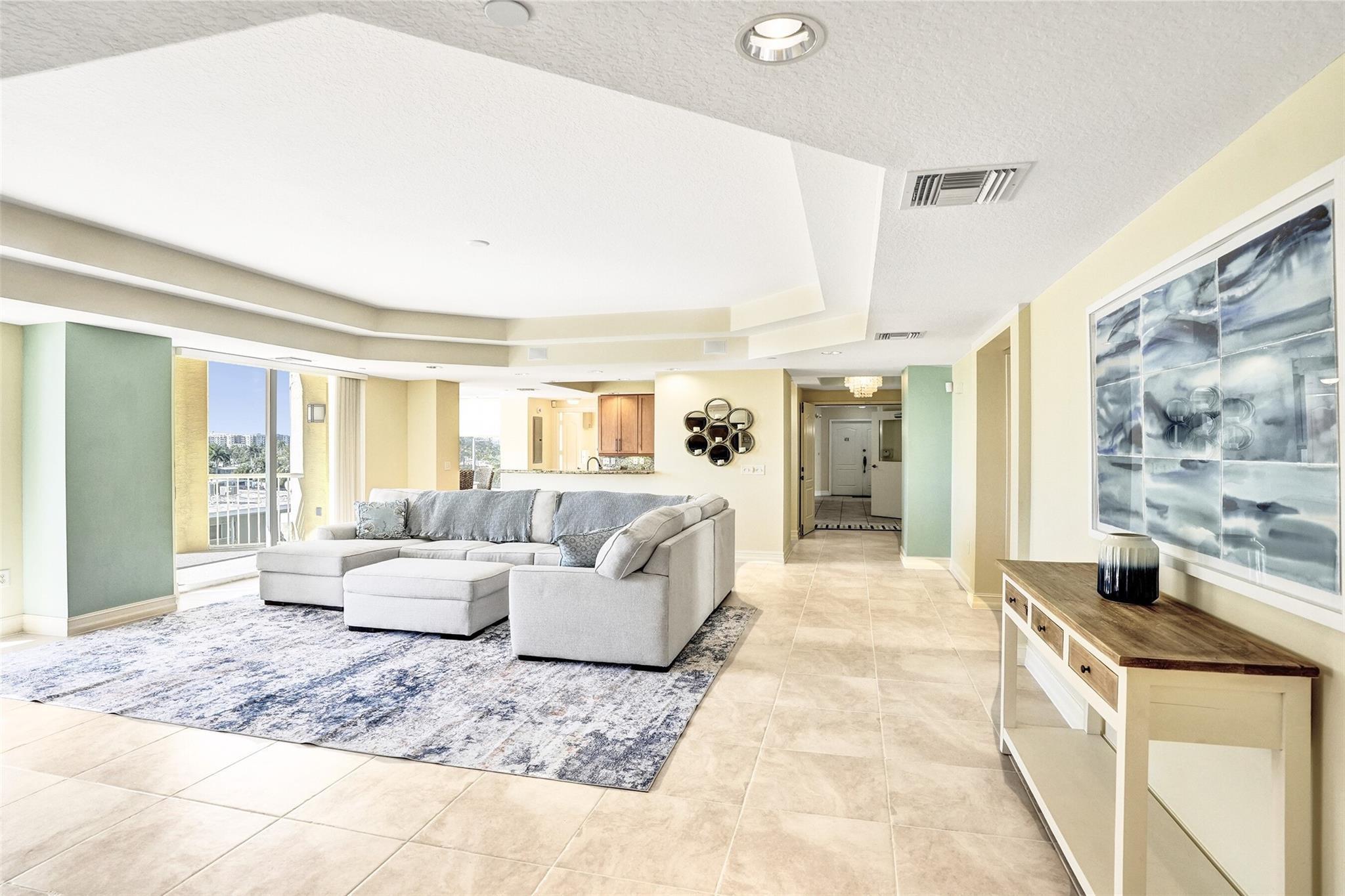 Image 2: spacious living room with high ceilings and lots o