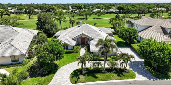 Image 2: Front with driveway and golf course