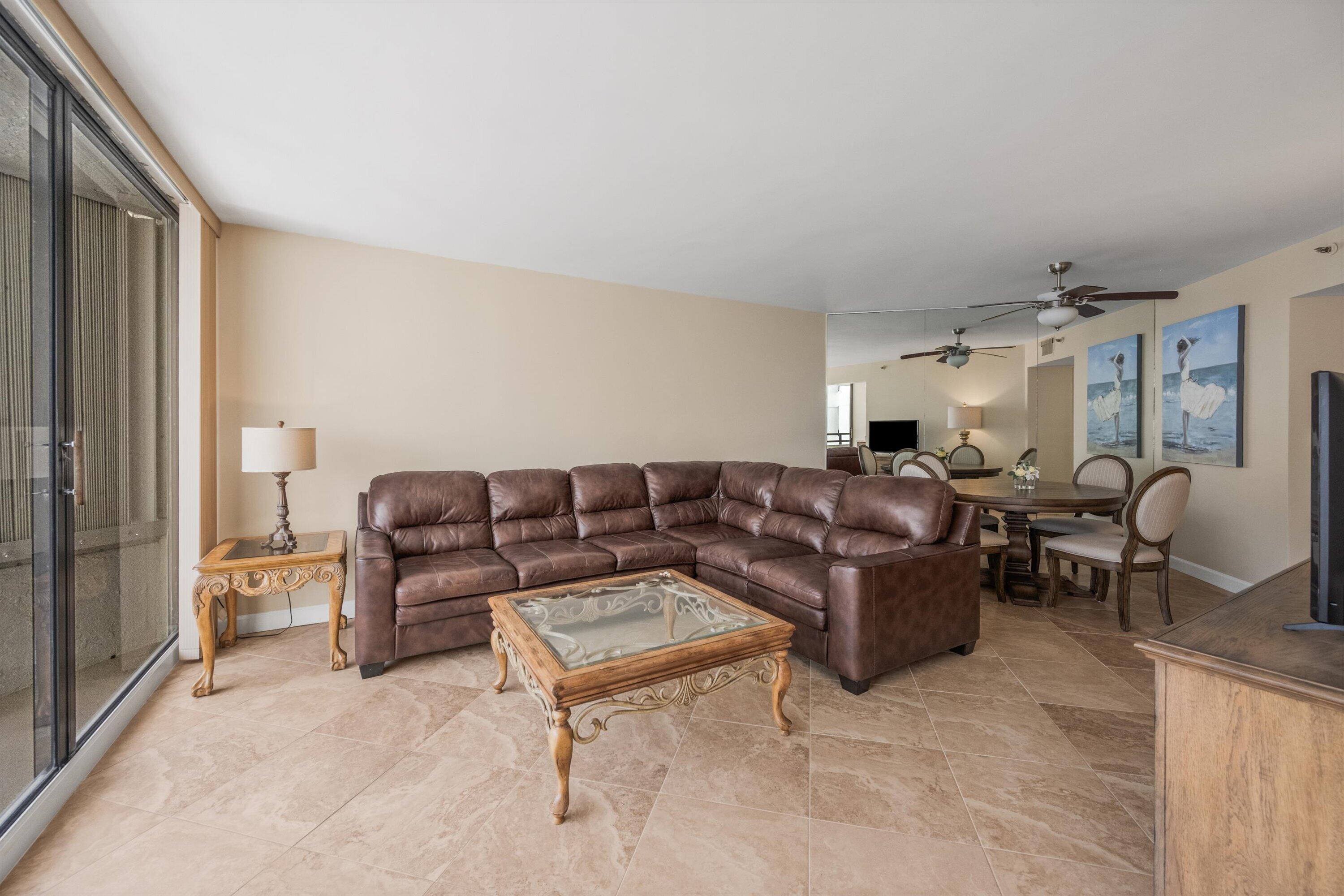 Image 4: Spacious living area featuring large format tile f