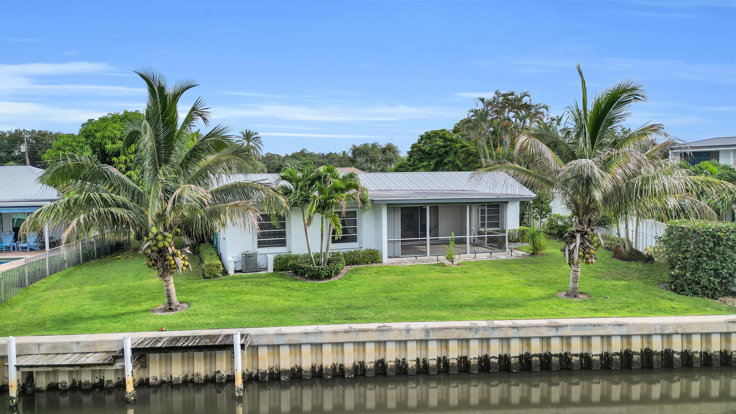 Image 3: Waterfront property featuring a seawall, private d