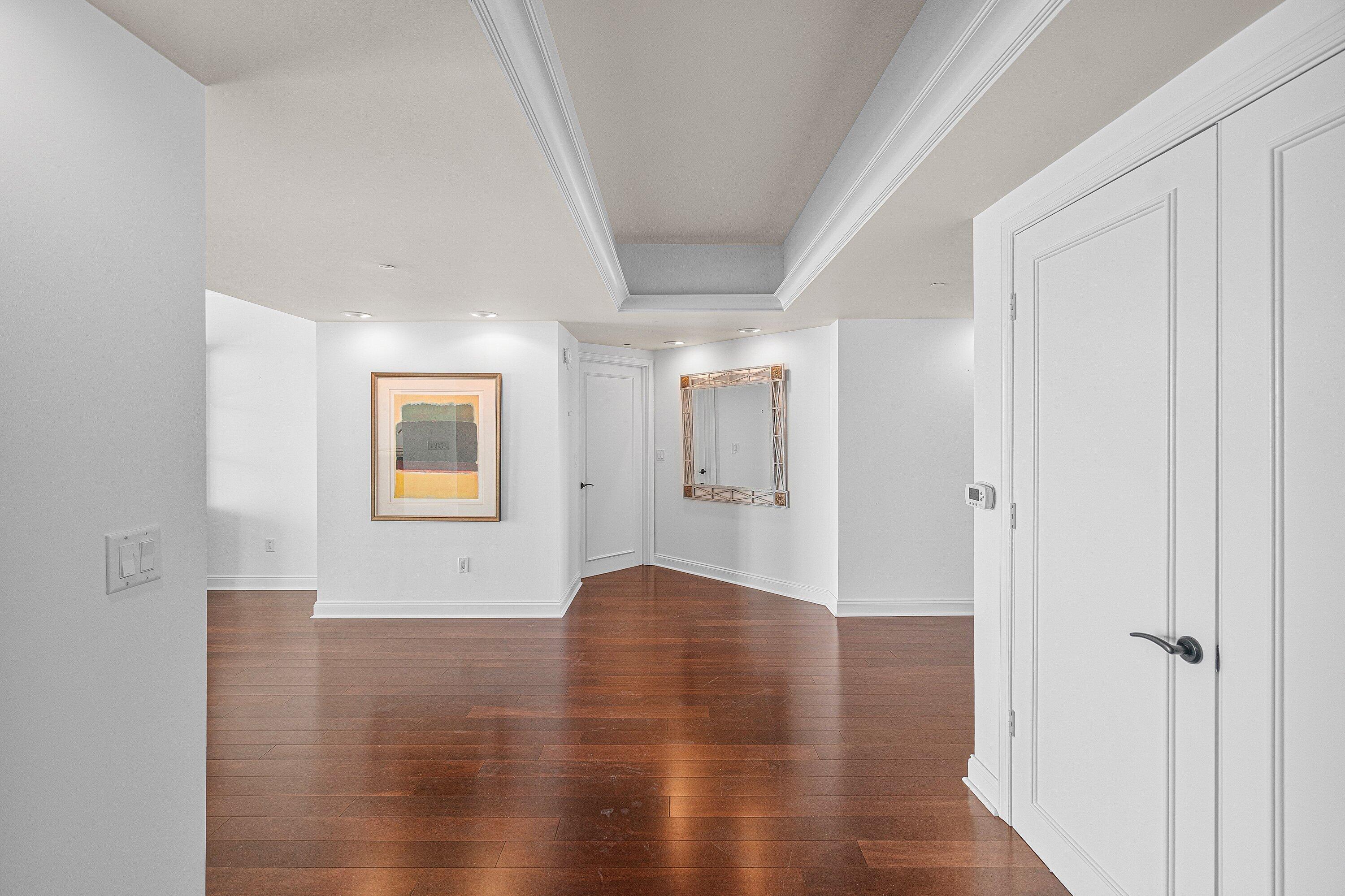 Image 4: A DOUBLE DOOR ENTRANCE INTO THE FORMAL FOYER