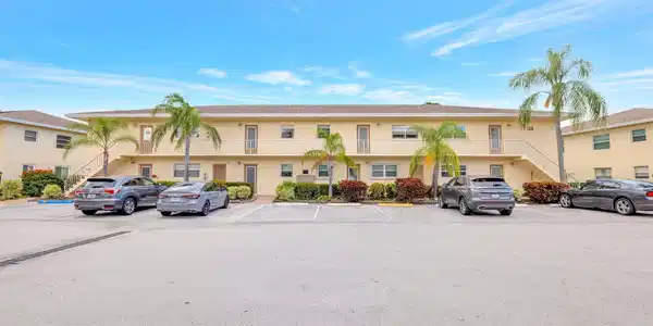 Image 3: Spacious parking and tropical landscaping welcome